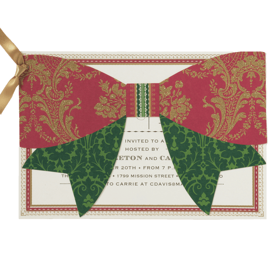 a red and green bow tie on top of a card.