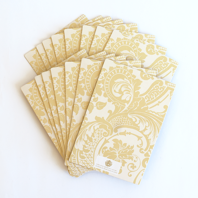 a set of six yellow and white paper napkins.