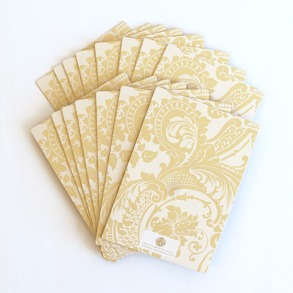 a set of six yellow and white paper napkins.