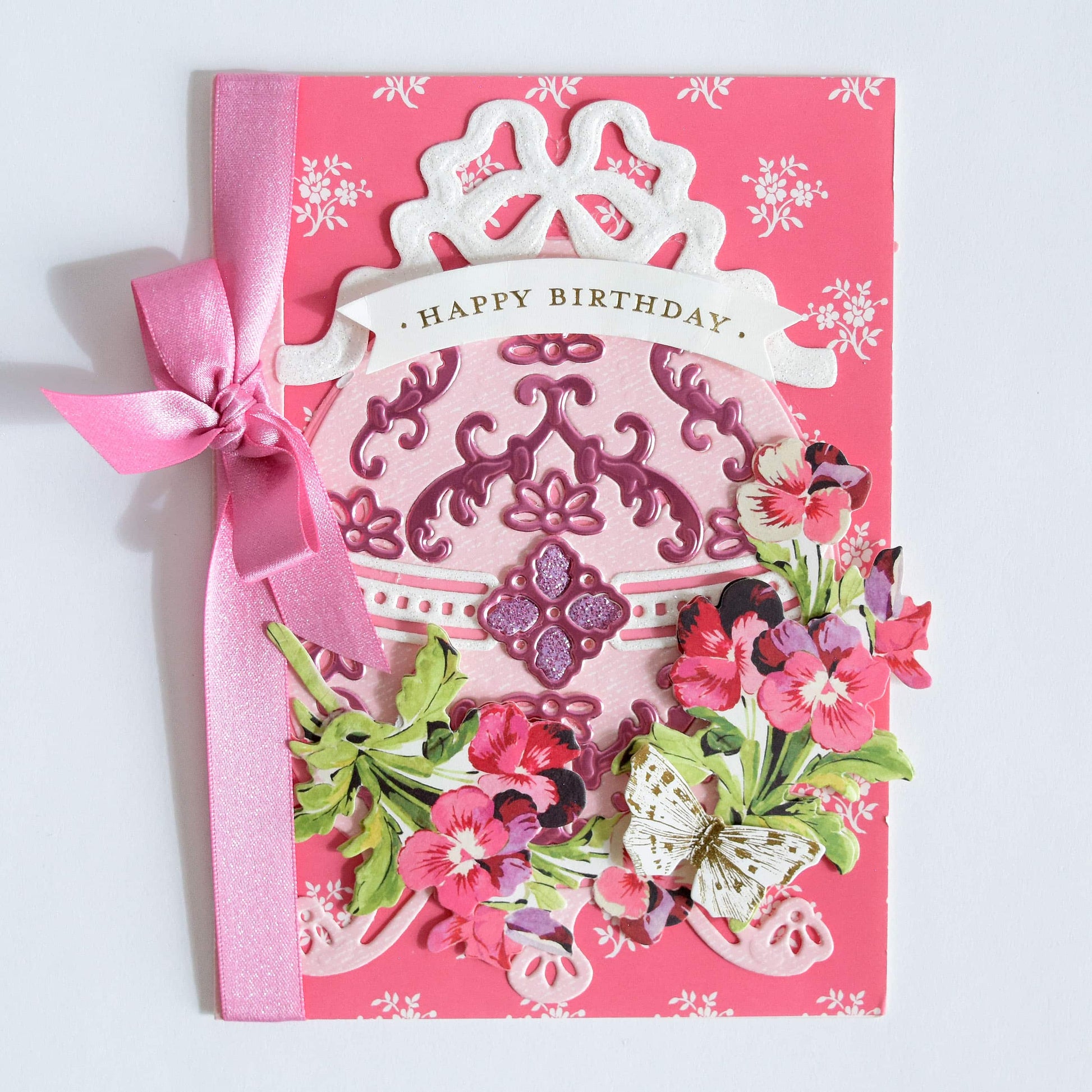 a pink birthday card with a tiara on it.