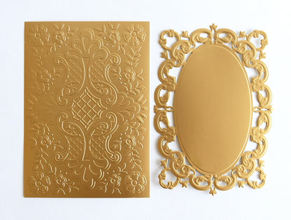 a mirror and a gold card on a white surface.