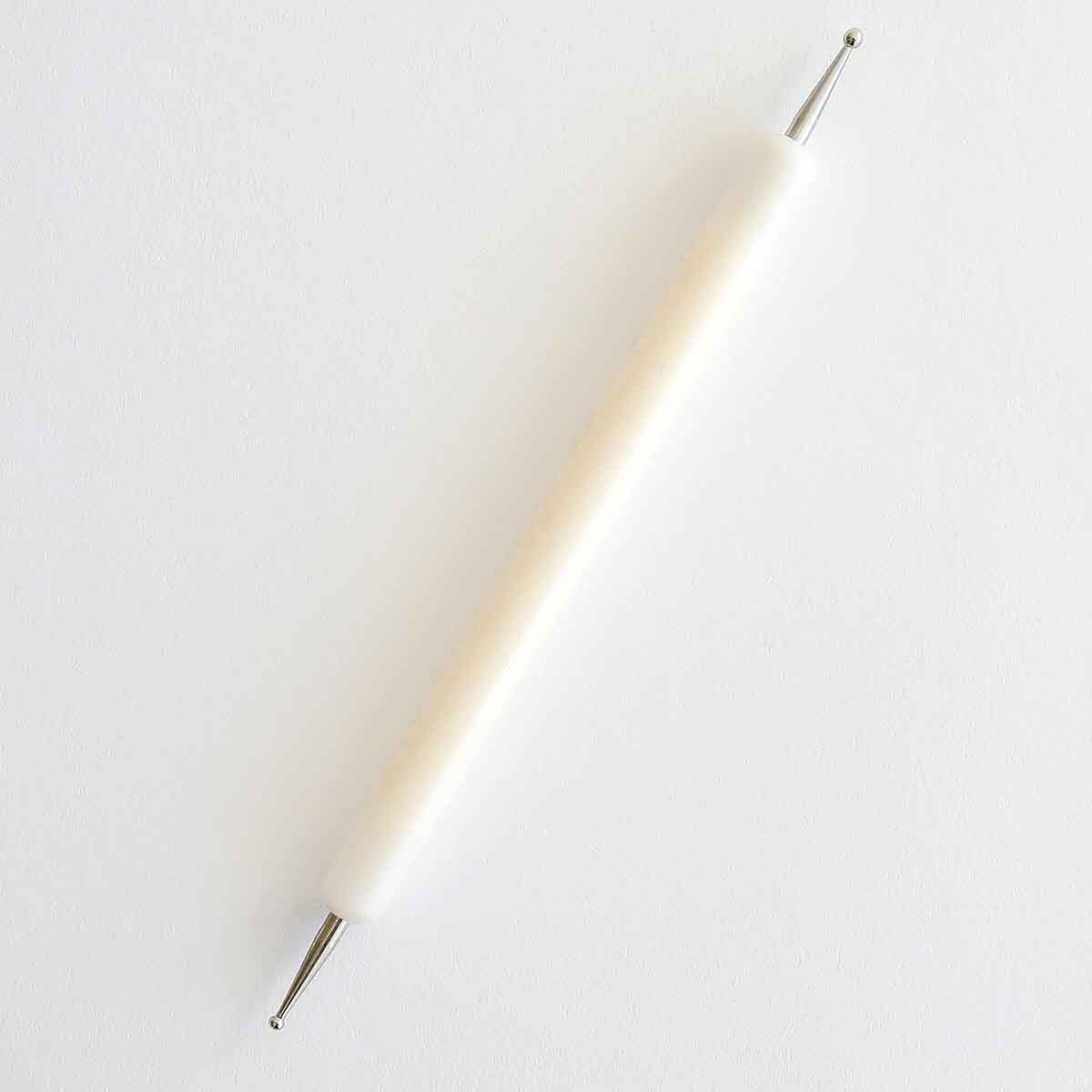 a white toothbrush on a white surface.