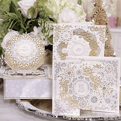 a table topped with lots of white and gold cards.