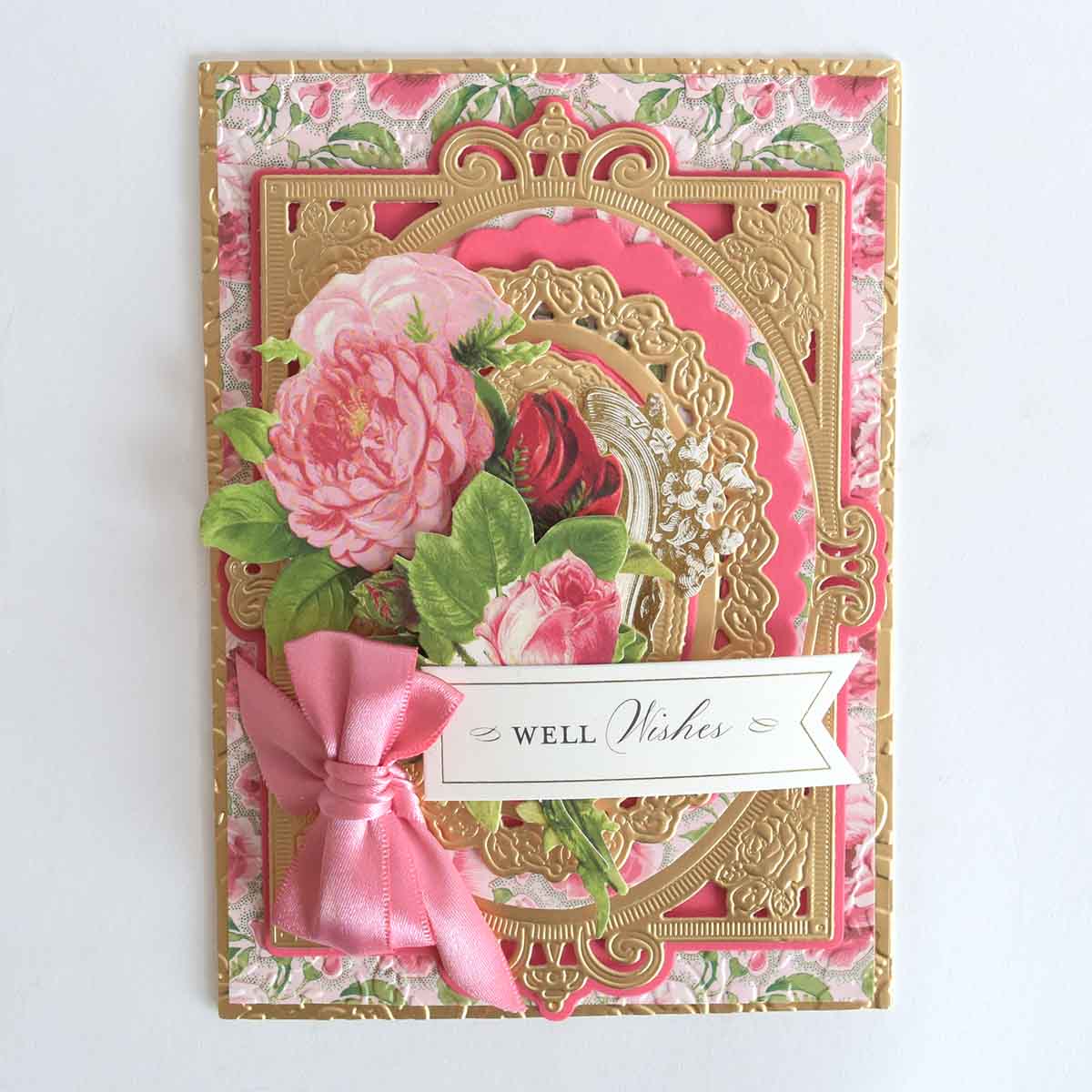 a close up of a card with a pink ribbon.