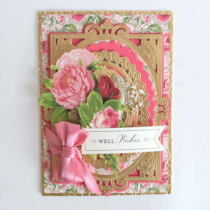 a close up of a card with a pink ribbon.