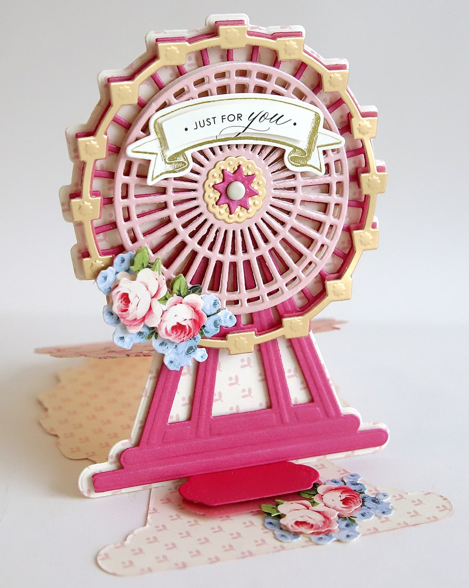 a card with a pink ferris wheel on top of it.