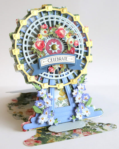 a miniature ferris wheel with flowers on it.