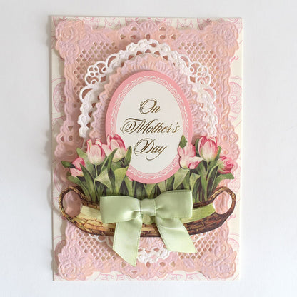 a mother's day card with pink flowers and a green bow.