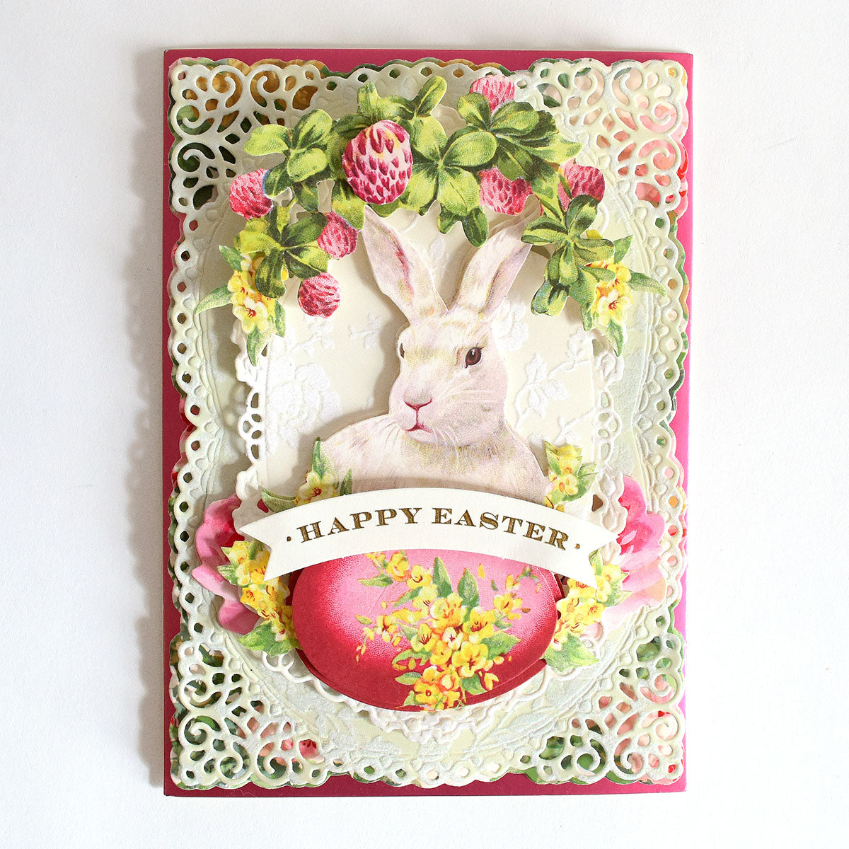 a happy easter card with a white rabbit.