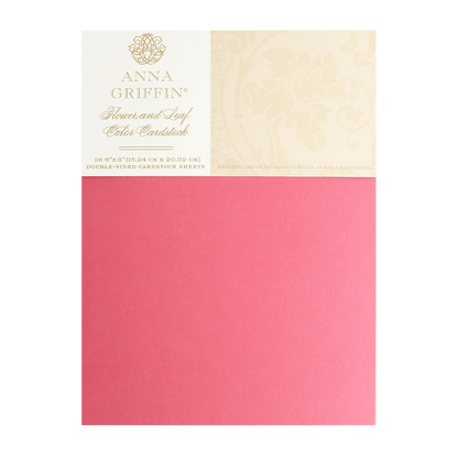 a pink envelope with a gold foil stamp on it.