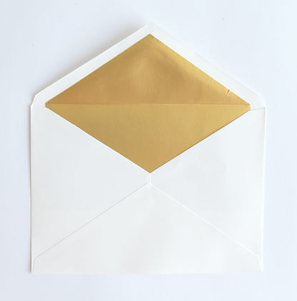 a white envelope with gold foil on it.