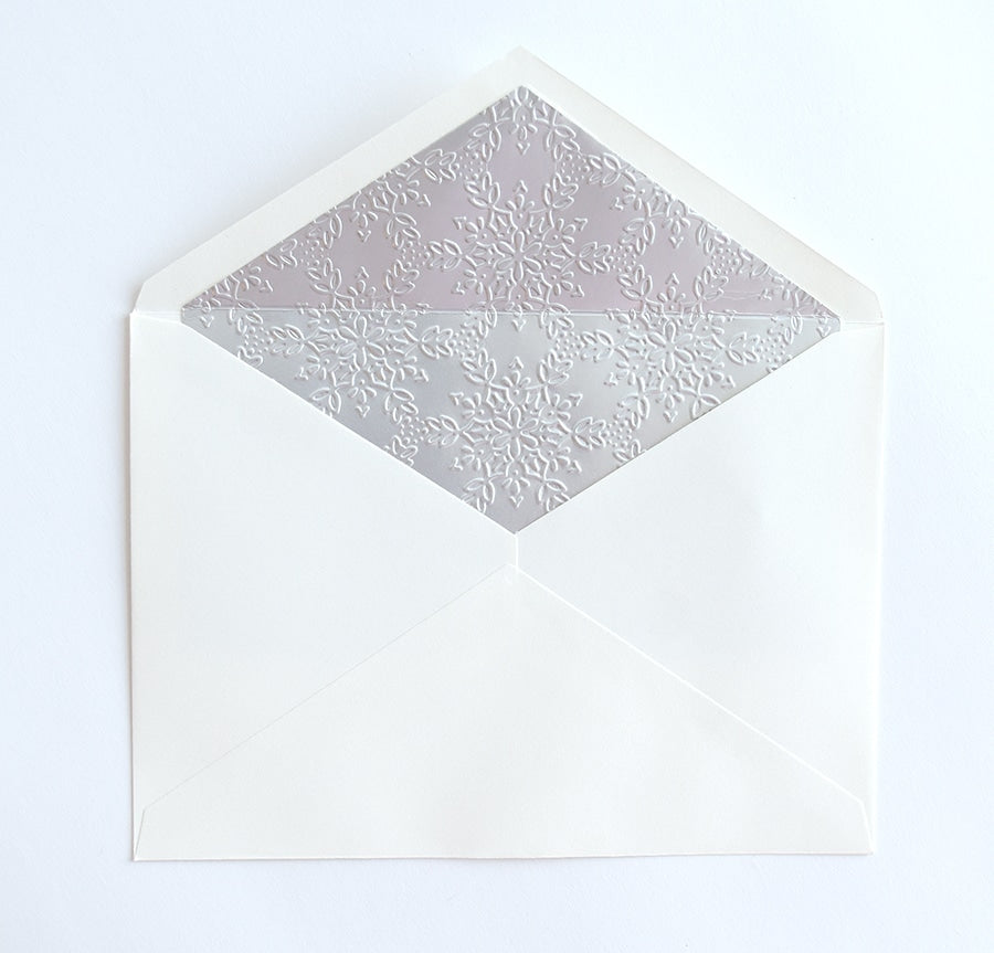 a white envelope with a white and silver pattern.