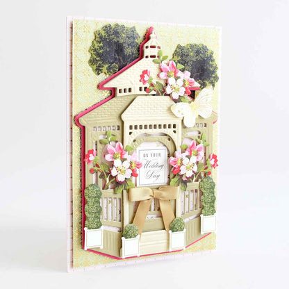 a card with a house and flowers on it.