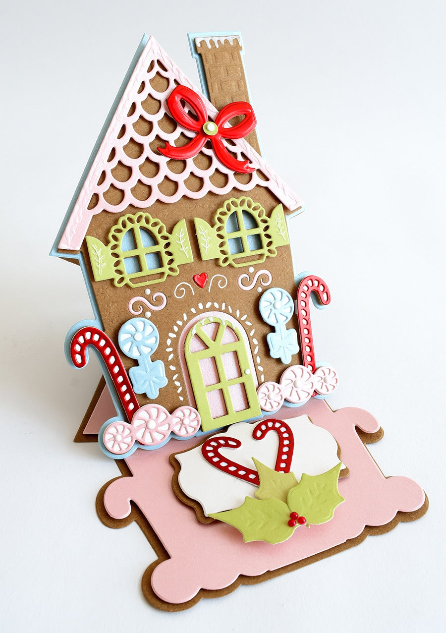 a card with a gingerbread house on it.