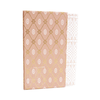 a pink and white paper with gold foil on it.