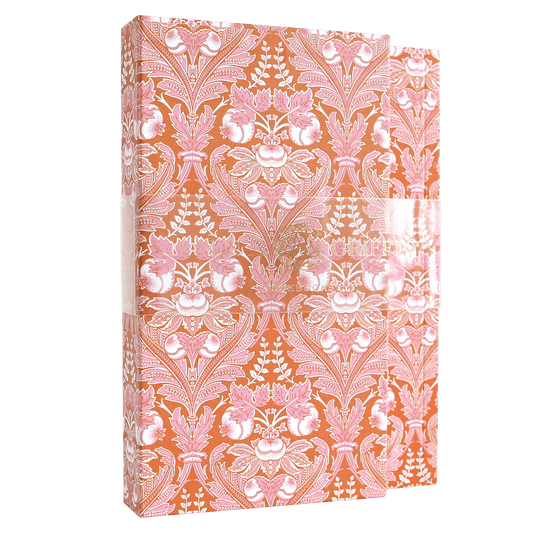 a pink and white book with a floral pattern.