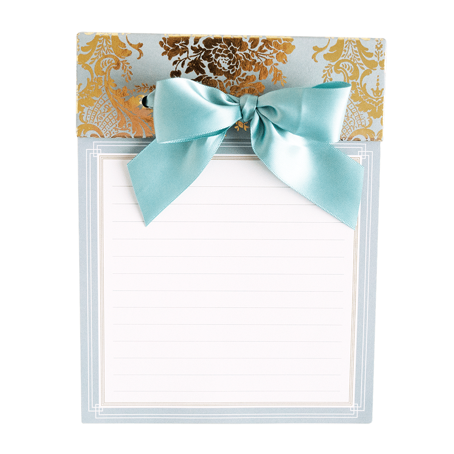 a notepad with a blue bow on top of it.