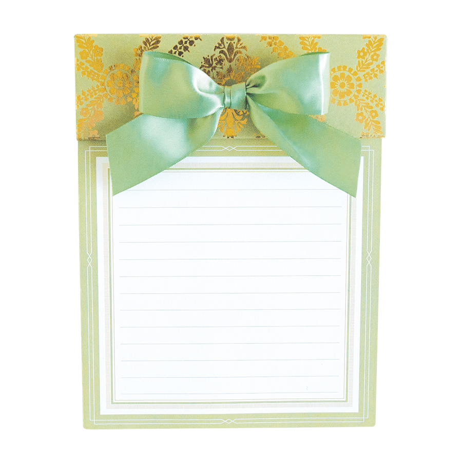 a note pad with a green bow on top of it.