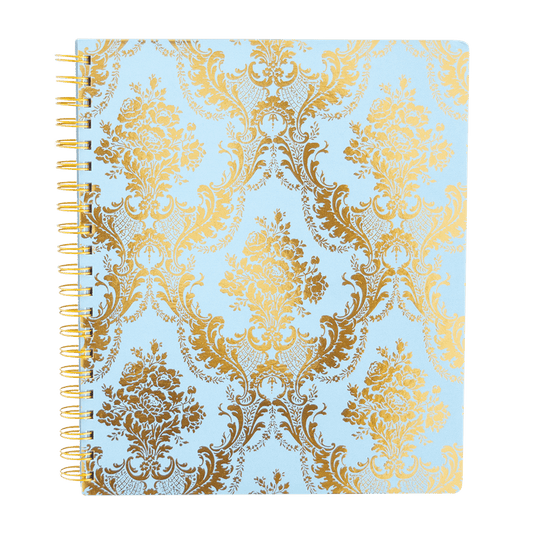 a spiral notebook with a gold and blue pattern.