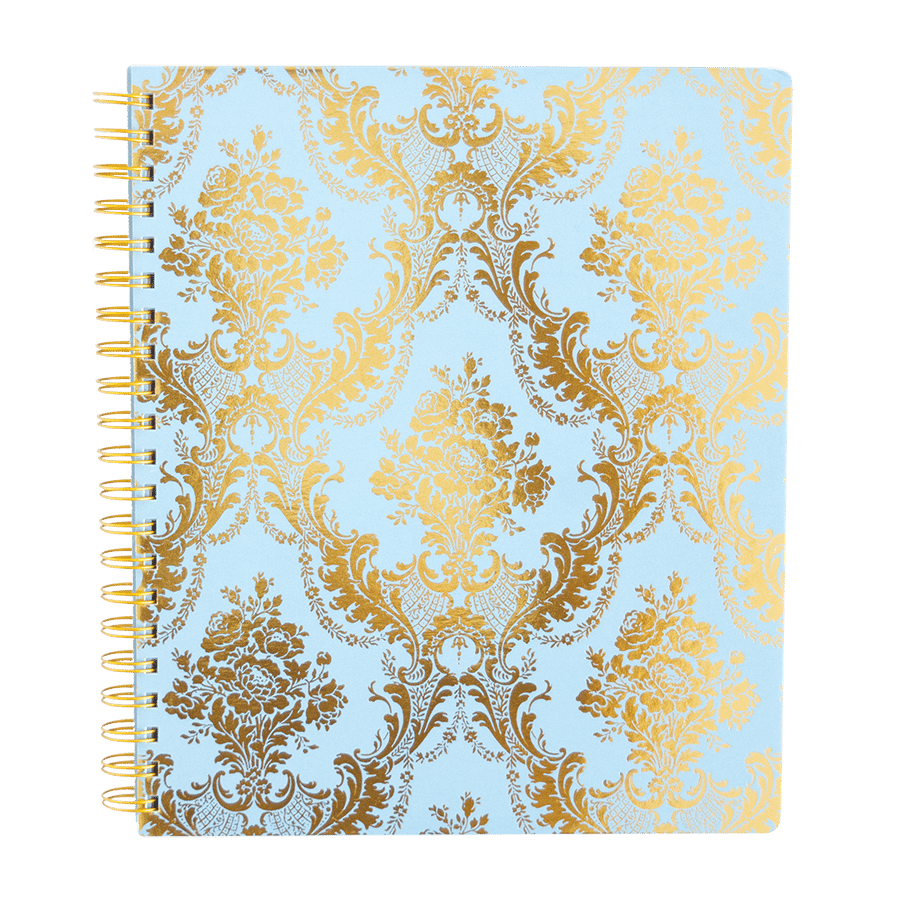a spiral notebook with a gold and blue pattern.
