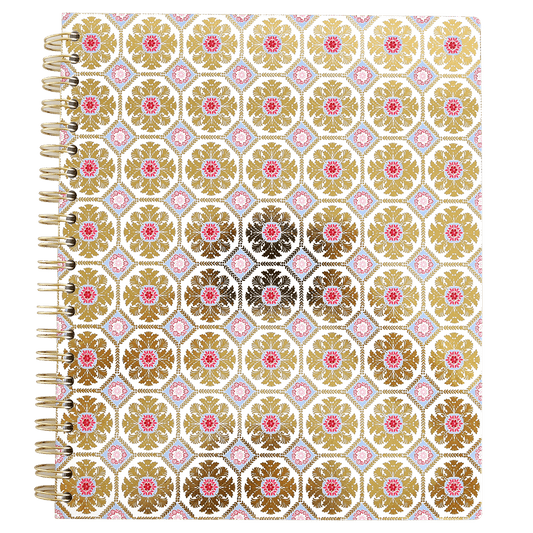 a spiral notebook with a gold and pink pattern.