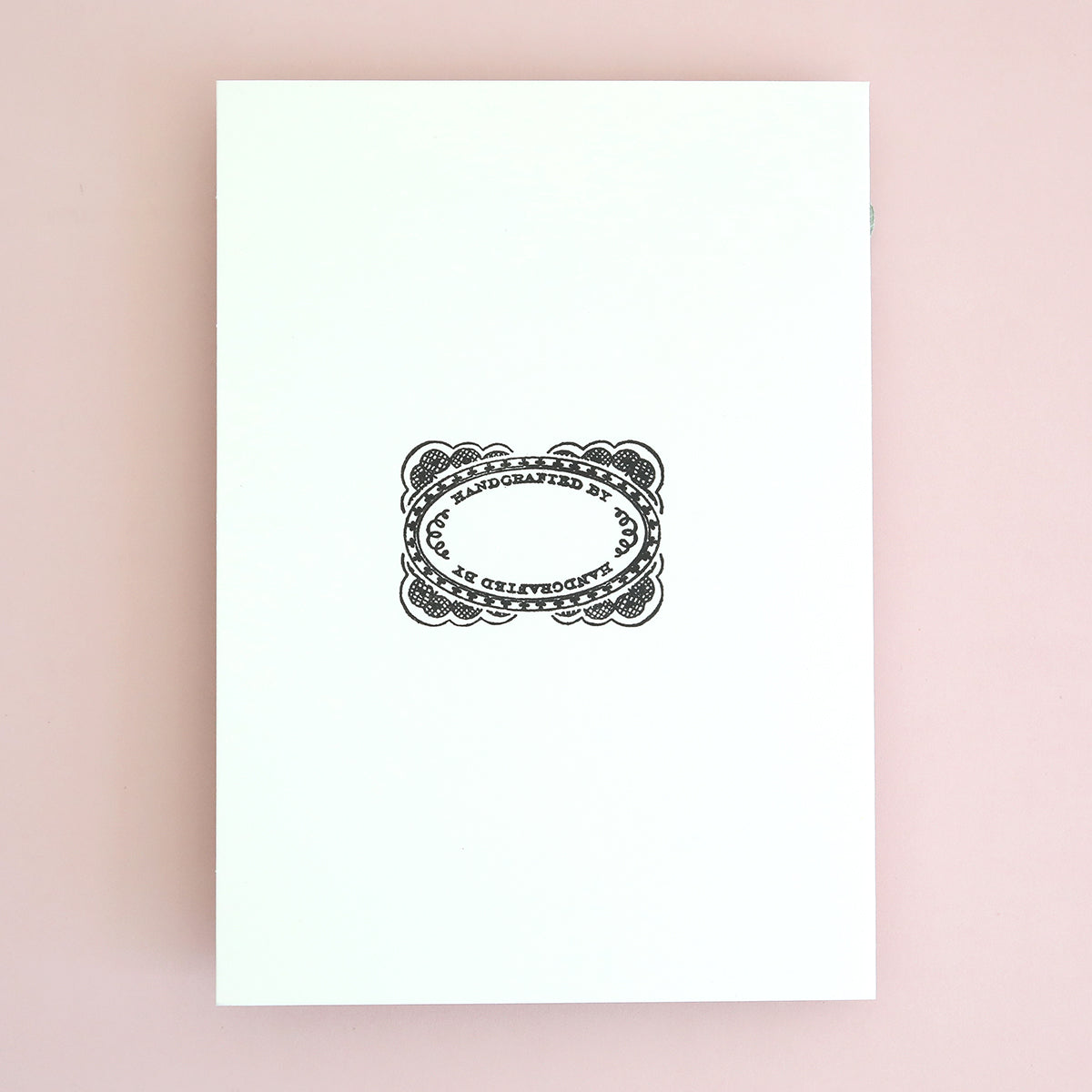 a white book with a picture of a ring on it.
