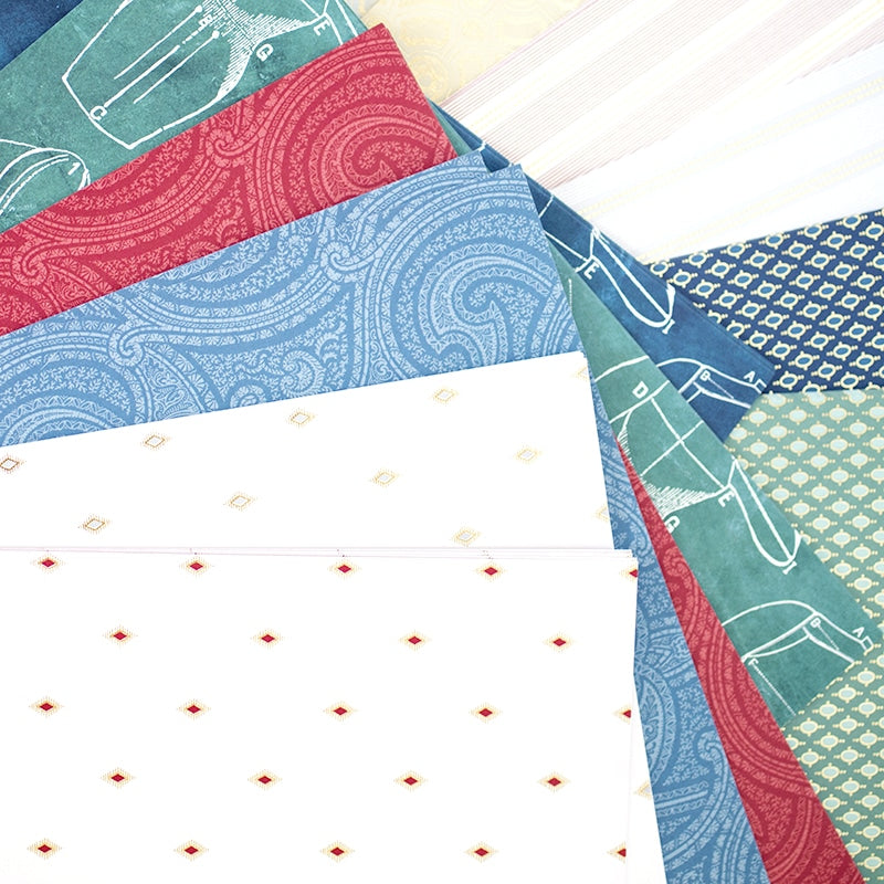 a close up of a pile of different colored papers.