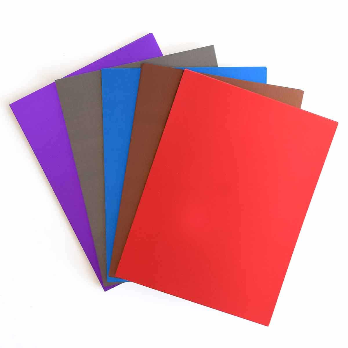 five different colors of paper on a white background.