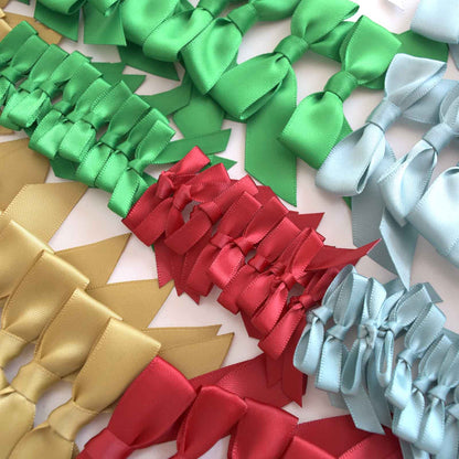 a group of different colored bows on a table.