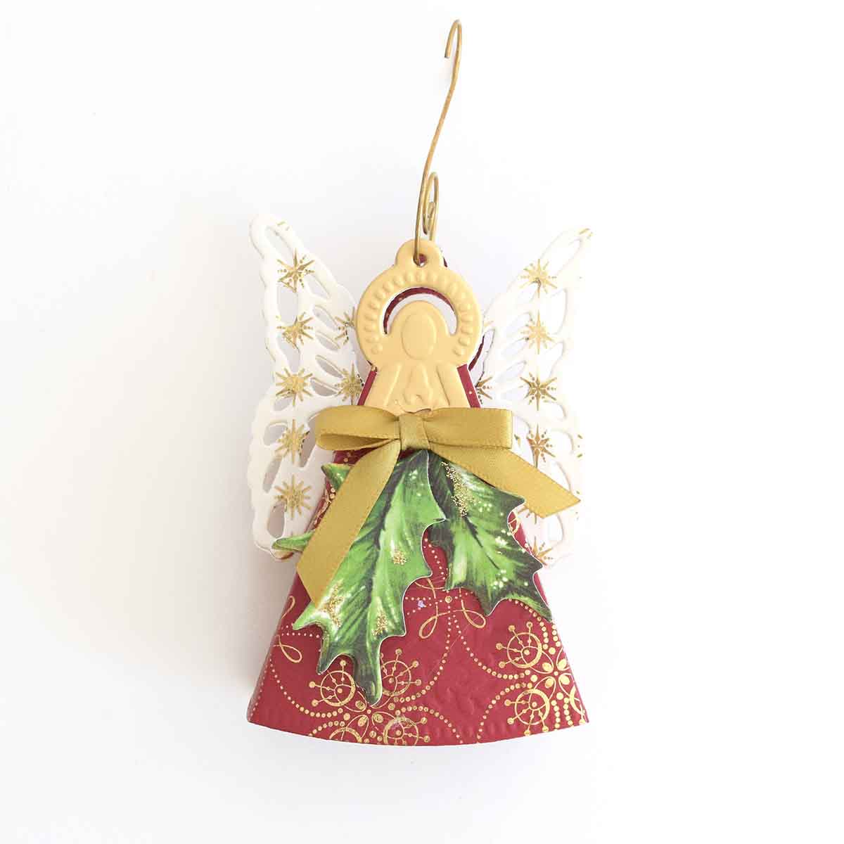 a christmas bell ornament hanging from a wall.