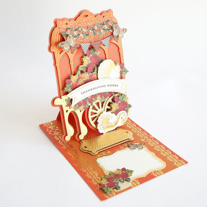 A pop up card with a haunted flower cart/shop embellishments.