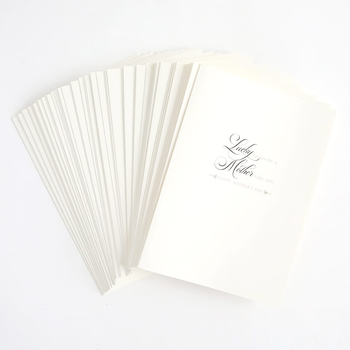 a stack of white folded cards with a black ink pen.