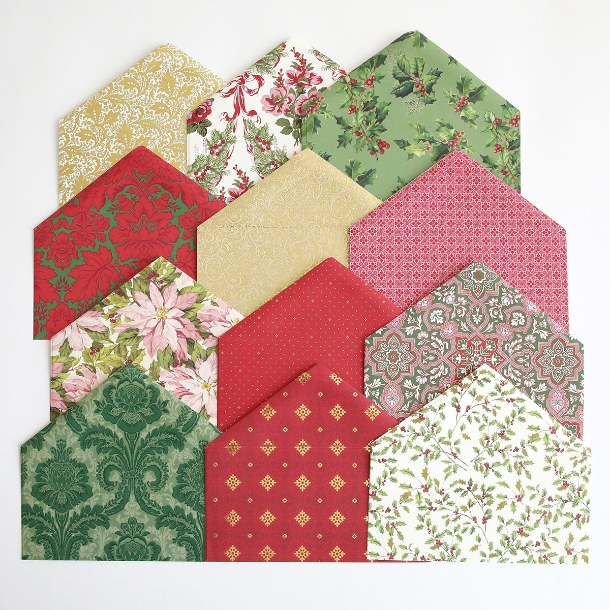 A group of Holiday Envelope Liners with red and green designs.