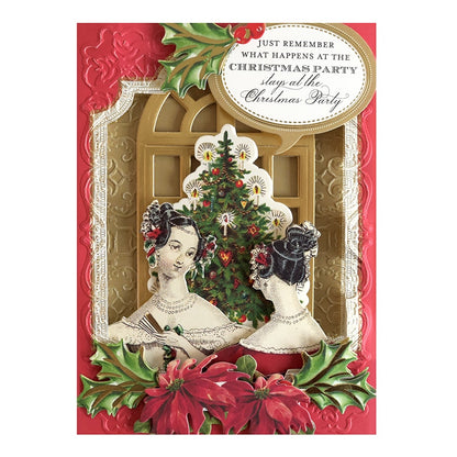 a christmas card with two women in front of a christmas tree.