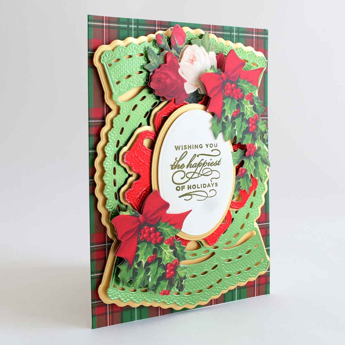a christmas card with holly and poinsettis.