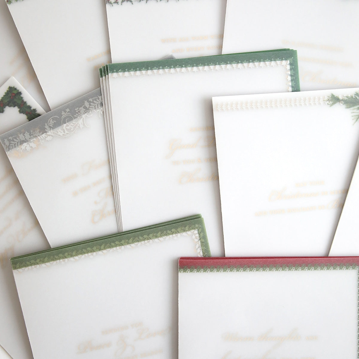 a group of Holiday Vellum Card Sentiment Inserts with Foil with a white and green border.
