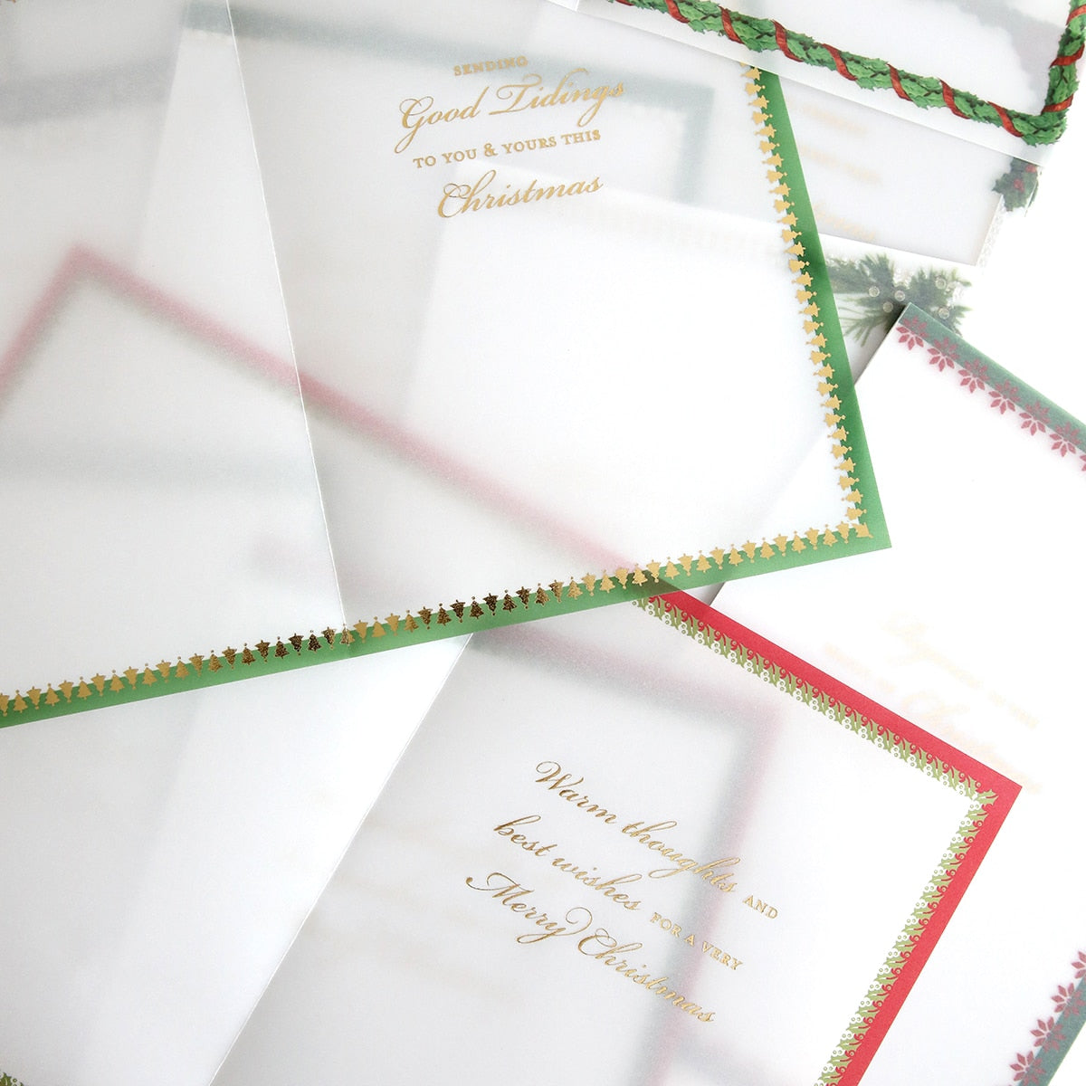 a set of Holiday Vellum Card Sentiment Inserts with Foil with red and green envelopes.