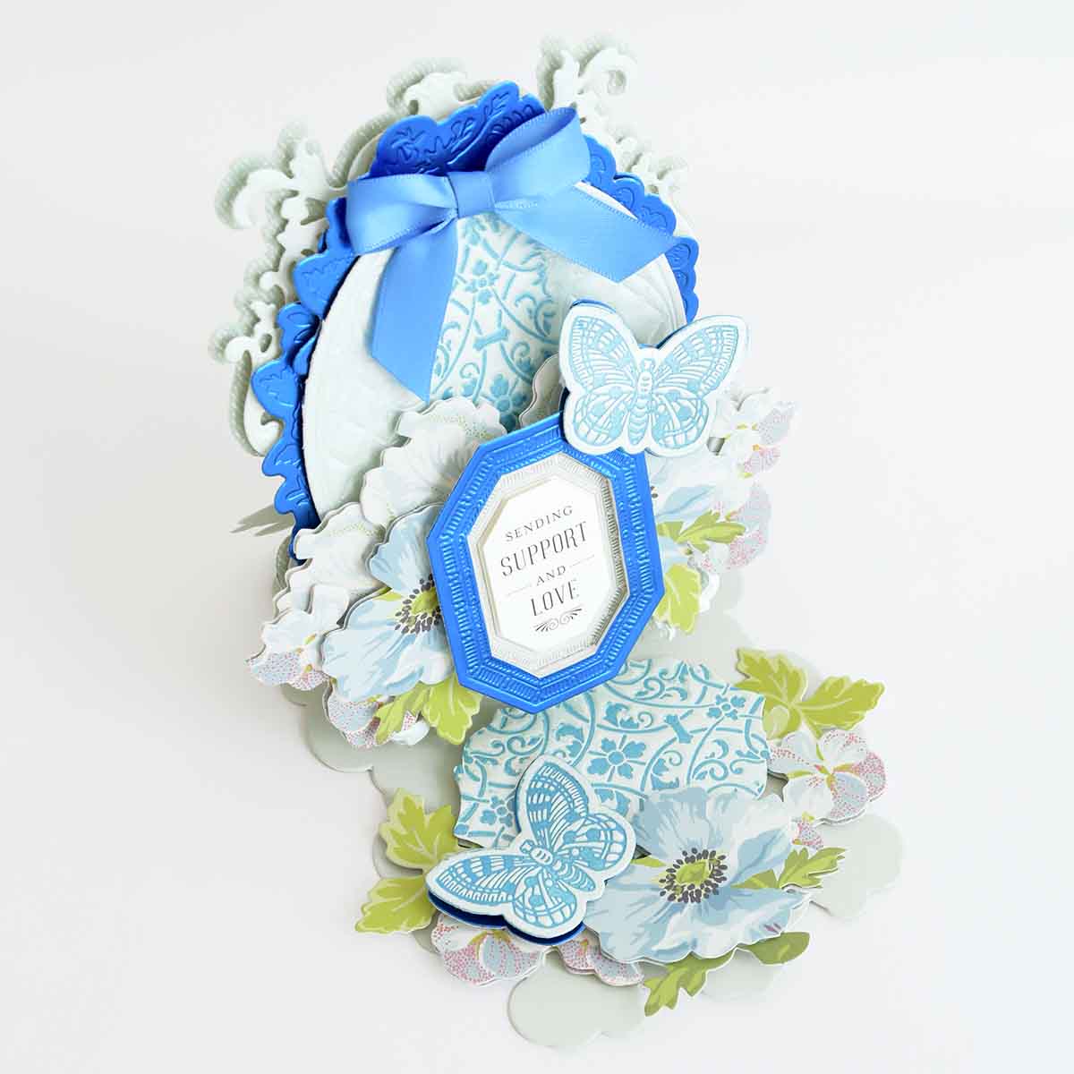 a close up of a card with a blue ribbon.