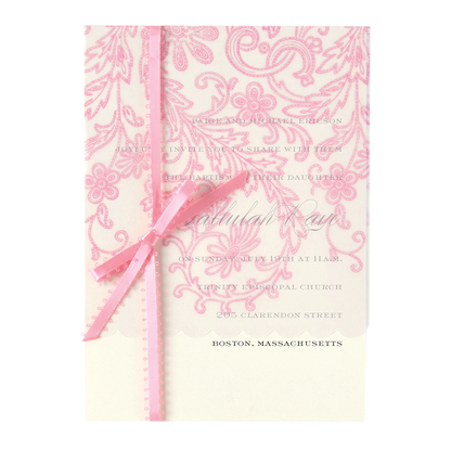 a pink and white wedding card with a ribbon.