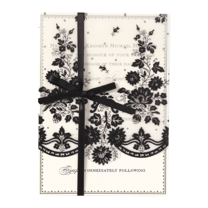 a black and white card with a ribbon on it.