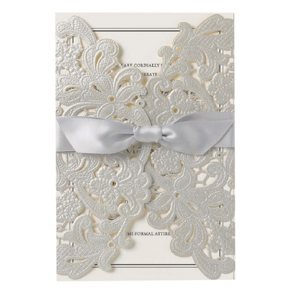 a white wedding card with a bow.