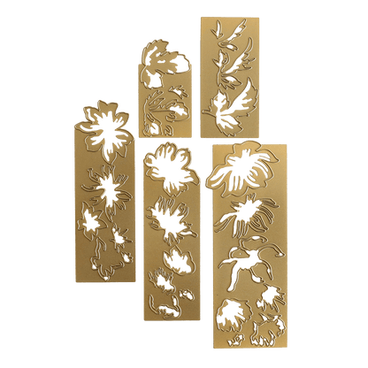 three gold bookmarks with green and white designs on them.