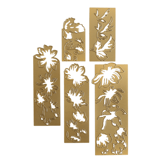 three gold bookmarks with green and white designs on them.