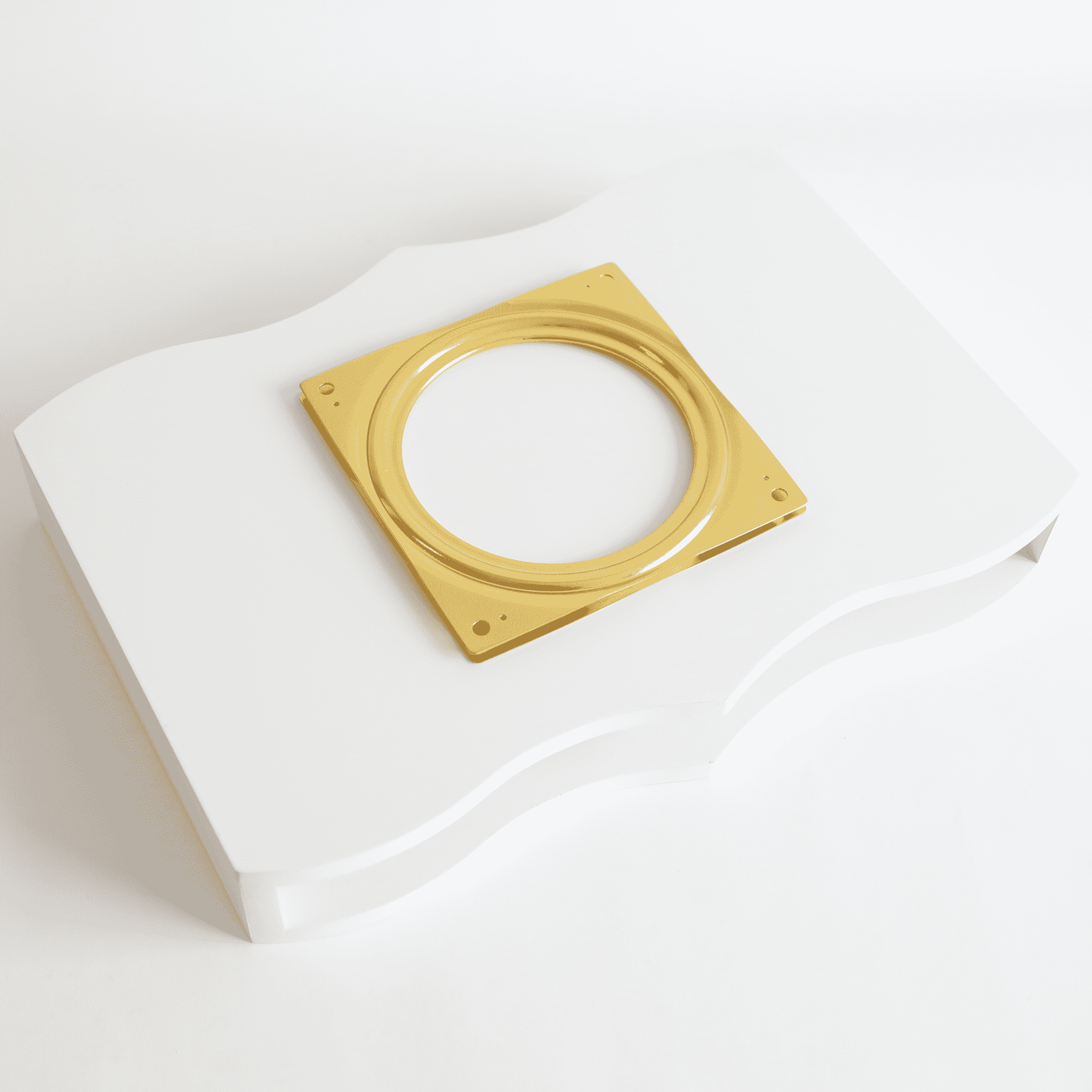 a white box with a gold ring on top of it.