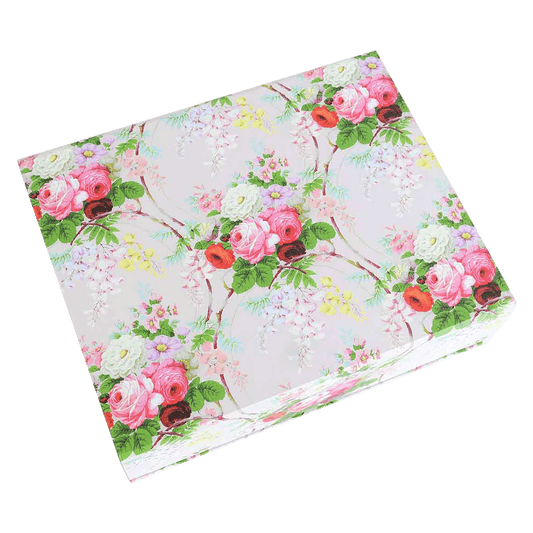 a pink and green flowered napkin on a green background.