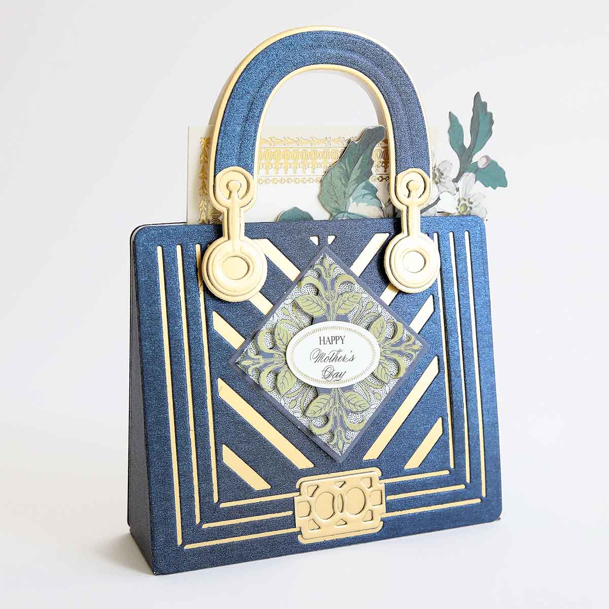 a blue and gold purse with a picture of a woman's face on it.