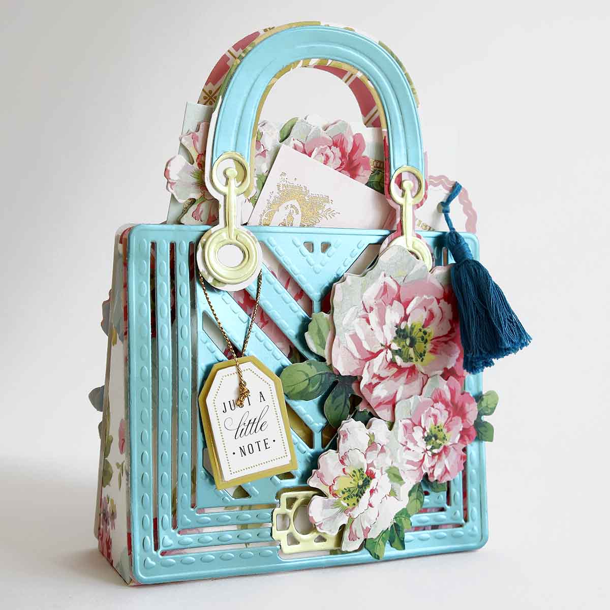 a blue purse with a bunch of flowers on it.