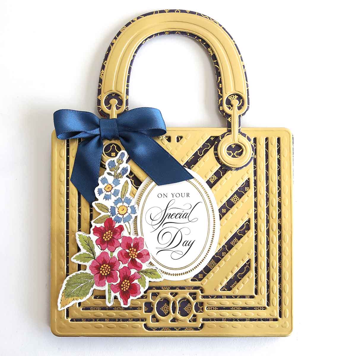 a handbag with a blue ribbon and flowers on it.