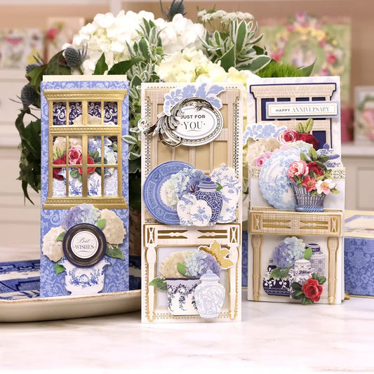 a table topped with blue and white plates and vases.