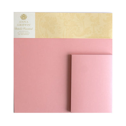 a close up of a pink and yellow envelope.
